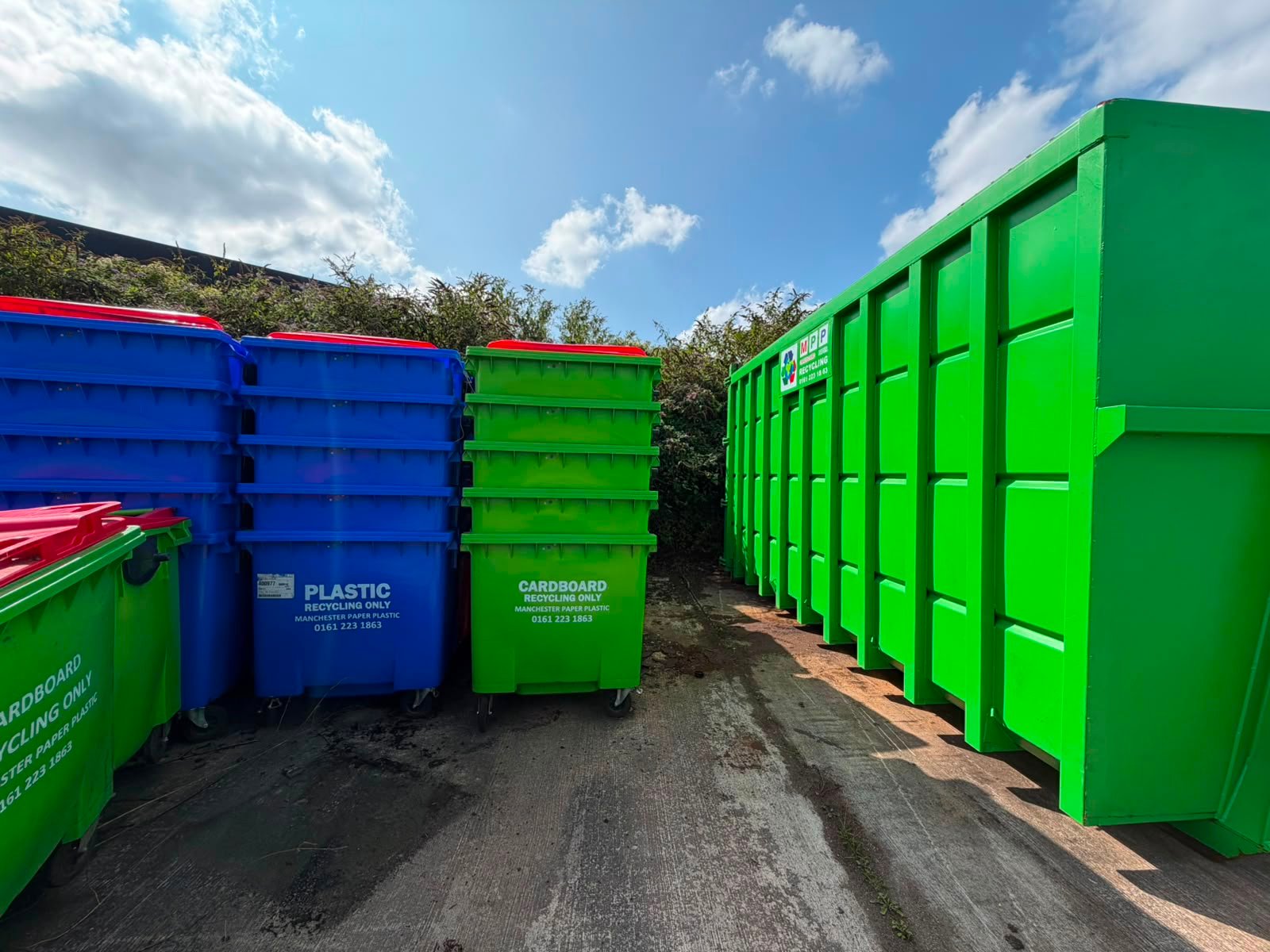 Cardboard recycling skip and bins at a commercial site