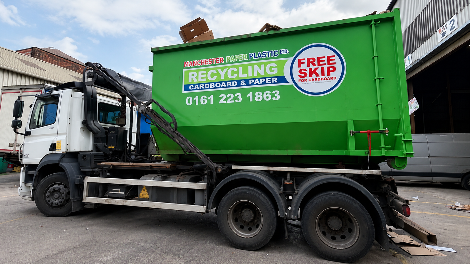 Skip hire truck delivering a recycling skip